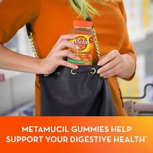 Metamucil Fiber Gummies bottle held above a bag, no sugar added