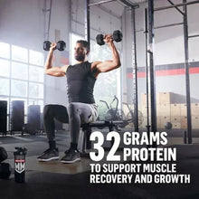 Protein shaker bottle on gym floor near man holding dumbbells