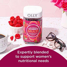 OLLY women’s multivitamin gummy bottle on table with berry theme and slogan-style label.