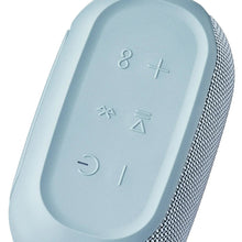Close-up of blue speaker top with control buttons and textured fabric speaker grille edge