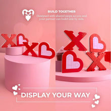 XOXO brick sign blocks in red and pale pink displayed on round pedestal