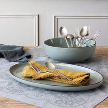Two-piece serving set with a serving bowl of cutlery and a plate with wrapped chips