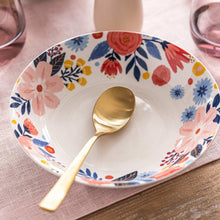 Floral dinner bowl with gold spoon, white ceramic with pink rose and blue flower design