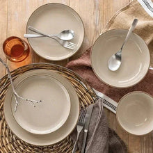 Ceramic 16-piece dinnerware set in beige, with plates and bowls at a table setting