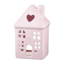 Pink ceramic house tabletop decoration with heart cutout windows and door