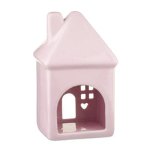 Pink ceramic house decoration with heart window cutouts and arched doorway