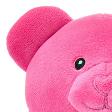 Pink gummy bear plush close-up with stitched snout and green eyes