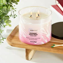 Raspberry peach frose 3-wick candle burning in pink ombre jar with black lid