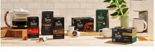 Peet's Coffee single-serve pod boxes with cups and coffee brewer on countertop