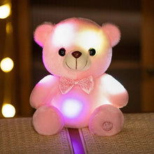 Pink teddy bear plush with bow tie, LED lights glowing on belly and head