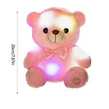Pink teddy bear plush with bow tie, glowing LEDs; approx 20 cm tall