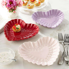 Set of heart appetizer plates, red, lavender, and white on table