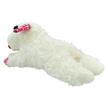 White plush lamb dog toy stretched out with red heart-pattern bow and feet