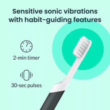 white toothbrush head with bristles on a black-and-white handle, for sonic vibration cleaning