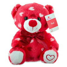 Red plush bear with white heart pattern and bow, gift tag attached
