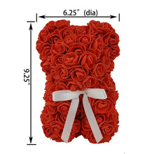 Red artificial rose bear figure with white ribbon bow, front view