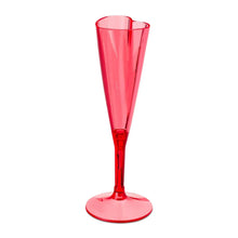 Red plastic champagne flute with heart-shaped rim and round base, angled view