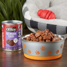 Dog food in bowl with gravy cuts, Ol' Roy filet mignon flavor can in background