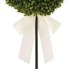 White bow ribbon detail on green heart topiary stem