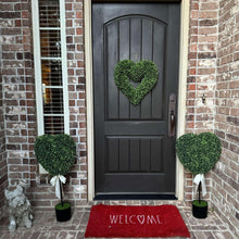 Pair of green heart topiaries with white bow ribbons in black pots