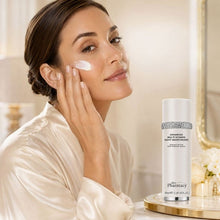 Night moisturizer on face with pump bottle; white cream on cheek and silver collar bottle