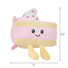 Pink plush cake with smiling face, tan base, and white top with pink heart sprinkles