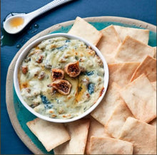 Pita chips with creamy dip in bowl, served with folded pita wedges