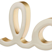 Cream Love tabletop decoration close-up, gold-tone inner surfaces on sculpted letters
