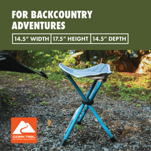 Collapsible camping stool with blue frame and gray fabric seat, placed on gravel