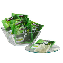 Green tea bags in a clear holder with Kirkland green tea packets