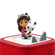 Cartoon girl audio figurine on a red Toniebox base with a white cat companion