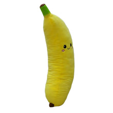 Yellow jumbo banana plush with green stem and embroidered face, angled side view