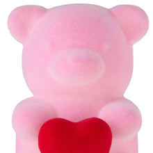 Pink flocked bear tabletop decoration, close-up of face and ears