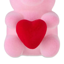 Pink flocked bear tabletop decoration with red heart, close-up