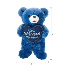 Blue teddy bear plush with navy heart patch “You Wrangled my Heart”; 21 in tall