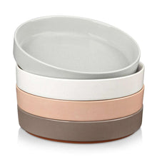 Stoneware bowl set with white, tan, and dark-brown stacked rings, speckled glaze.