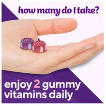 two berry multivitamin gummies resting on an open hand