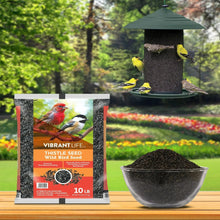 10 lb thistle seed bag with black bowl bird feeder and scattered flowers backdrop