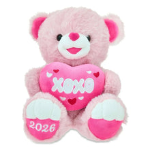 Pink teddy bear plush holding a pink heart patch with XOXO and 2026