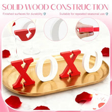 Wooden XO tabletop sign with red X and white O letters on a decorative tray