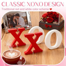 Wooden XO tabletop sign with red X and white O letters on a tabletop display