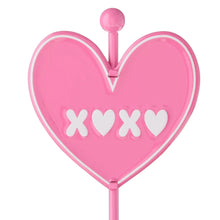 Pink heart tabletop sign close-up with XOXO letters and central notch